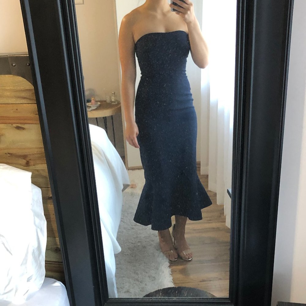 Strapless navy dress with ruffled hem